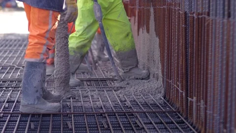 Building construction worker pouring cement on concrete Stock Footage 81537132