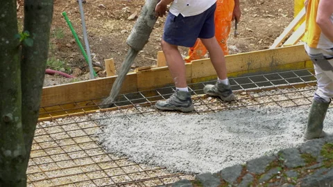 Building construction worker pouring cement or concrete with pump tube. Stock Footage 106532068