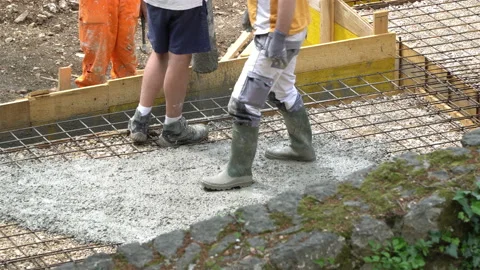Building construction worker pouring cement or concrete with pump tube. Stock Footage 106629960