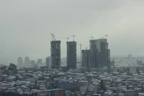 Building constructions under white snow and cold winter in city, Istanbul Фото