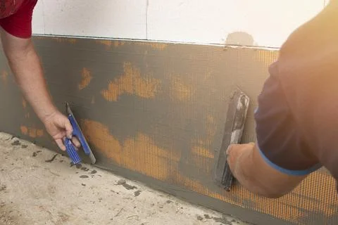 A building contractor is installing a reinforcing mesh Stock Photos