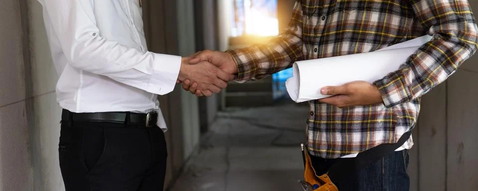 Building contractor shake hand with engineer or foreman after successful ne.. Stock Photos