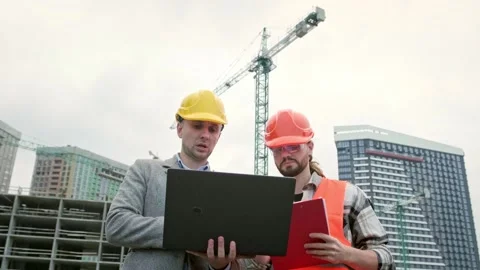 Building contractors using portable computer during site inspection Stock Footage 274394288