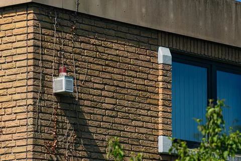 Building corner with alarm system installed on brick wall Stock Photos