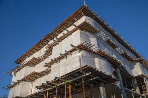Building Corner Under Construction with Metal Beams and Scaffolding Photos