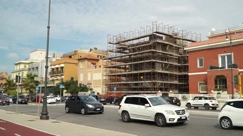 A building covered with scaffolding, with work stopped, on the waterfront Stock Footage 218240565