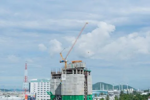 Building crane, engineering and building skyscraper under construction Stock Photos