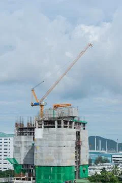 Building crane, engineering and building skyscraper under construction Stock Photos