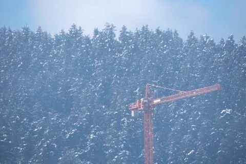 Building crane in a forest in the mountain. Selective focus Stock Photos