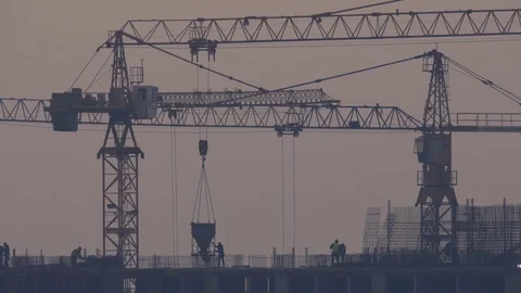 The building with cranes on a background of grey sky Stock Footage 118858987