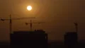 The building with cranes on a sundown background. time lapse 4k or 4k+ Resolution