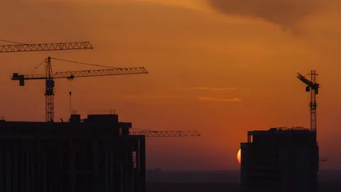 The building with cranes on the sunrise background. time lapse Stock Footage 107102525