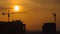 The building with cranes on the sunset background. time lapse 4k or 4k+ Resolution