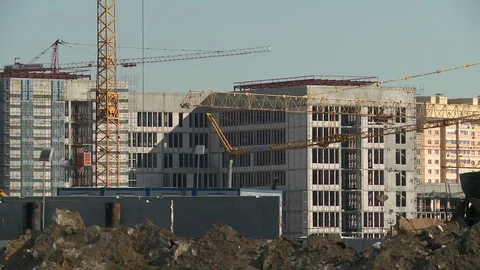 Building cranes working at a construction site Stock Footage 89586339
