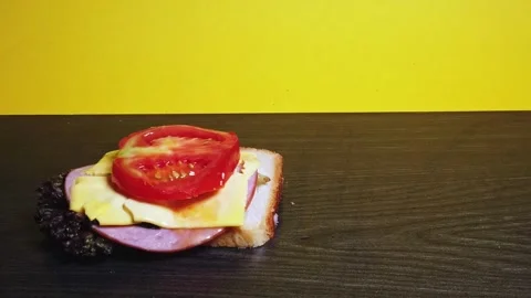 Building a delicious sandwich step by step adding tomato slice on cheese an.. Stock Footage 339203527