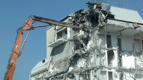 Building demolition by excavator Stock Footage 105934773