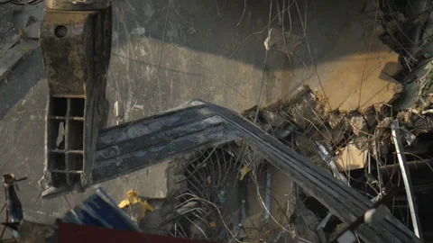 Building demolition. A huge machine arm destroys the house. Dust, debris, bricks Stock Footage 123501317