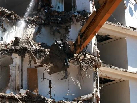 Building demolition machine pulls down a wall,blur Stock Photos