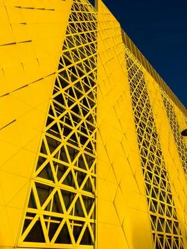 Building design features bright yellow exterior with geometric patterns in .. Stock Photos