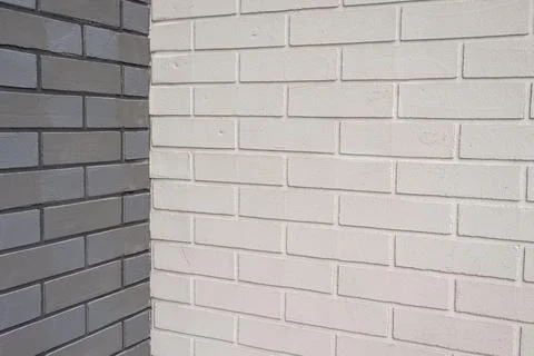 Building design featuring contrasting brick walls on a corner creating a graphic Stock Photos