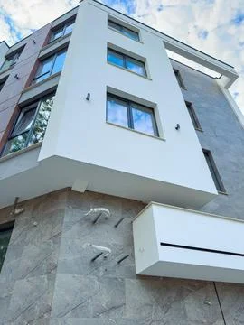 Building design with large windows and modern style in a residential area d.. Stock Photos