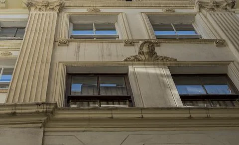 Building with detailed architecture features windows and decorative element.. Stock Photos