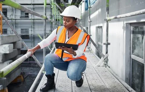 Building developments done digitally. a young woman using a digital tablet while Stock Photos