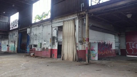 Building in disarray lays in ruin with graffiti painted on inside walls Stock Footage 88425336