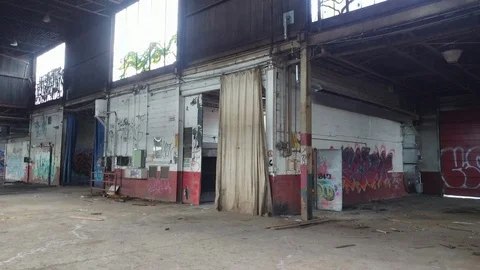 Building in disarray lays in ruin with graffiti painted on inside walls - 24fps Stock Footage 104119804