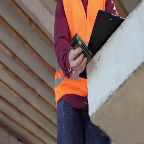 Building Engineer Does Measurements of the Building Stock-Footage 69514047