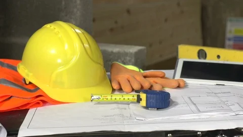 Building Equipment and tools on Construction Site - Helmet, Gloves, Plans, Stock Footage 128967473