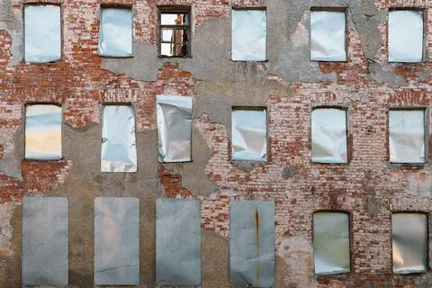 Building facade with boarded up windows . Stock Photos