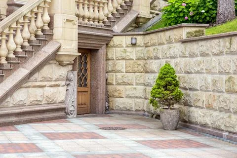 Building facade exterior with architectural elements of stone decor style. Stock Photos