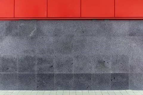Building facade featuring a contrast between vibrant red composite cladding a Stock Photos