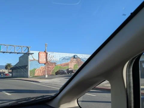 Building facade featuring hand-painted mural of moose and wilderness scene Stock-Fotos