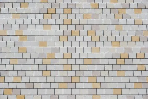 Building facade featuring rectangular stone tiles forming a geometric pattern Stock Photos