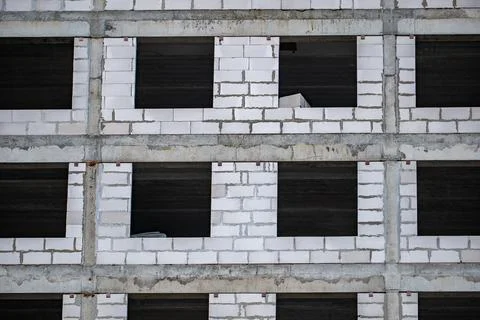 Building facade forming repetitive pattern with concrete beams and aerated Stock Photos