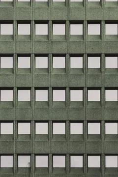 Building facade with a green grid pattern and square windows, in Rotterdam, Stock Photos