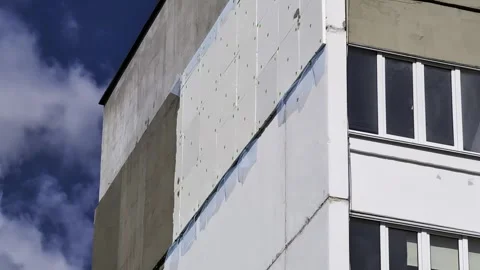 Building facade renovation process with insulation panels installation on Stock Footage 344845865