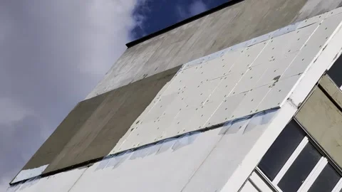 Building facade renovation process, partial installation of exterior insulation Stock Footage 344846019
