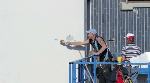 Building facade renovation, Workers on the elevator restoring buildings Stock Footage 54292849