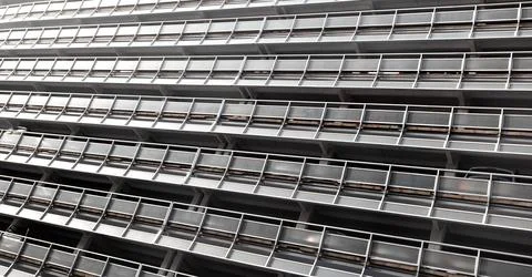 Building facade showing repeating pattern of modern architecture Stock Photos