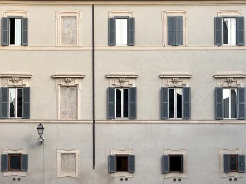 A building facade with shuttered windows Stockfoto's