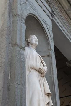 Building facade with typical statue of saint in Italy, Venice, Florence Stock Photos