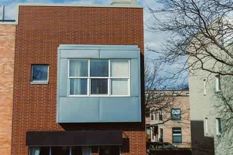 Building facade with a window in an urban setting during day Stock Photos