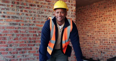 Building, face and hardhat with black man on construction site for property Stock Footage 336219907