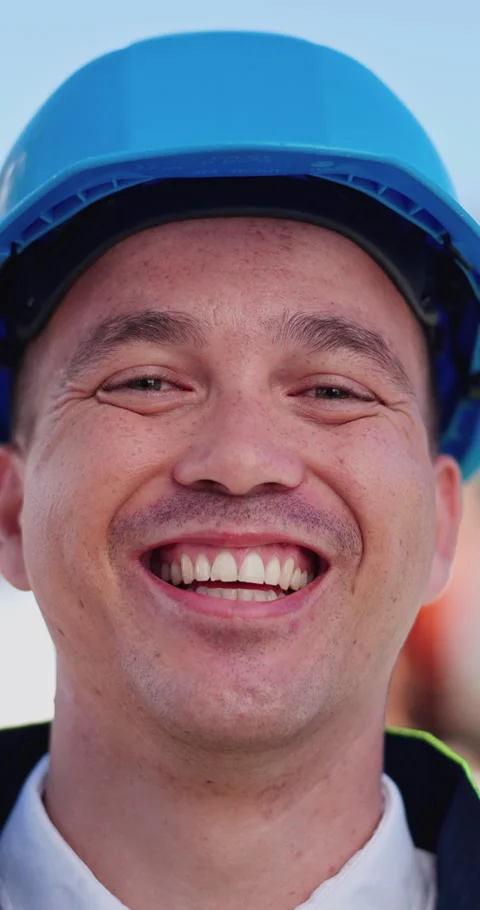 Building, face and smile of construction worker man outdoor for development or Stock Footage 313516457