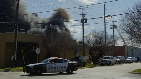 Building on fire creating road blocks Stock Footage 125343624