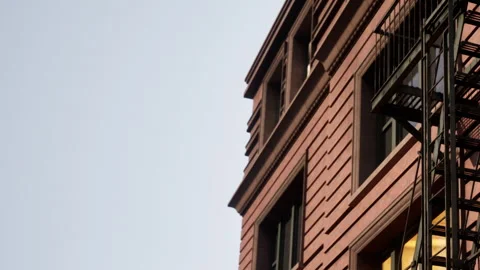 Building with fire escape under a clear sky in an urban area Stock Footage 342800325