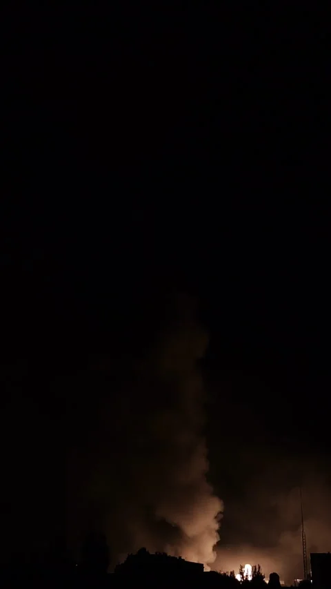 Building on fire at night following drone attack and blasts Stockbeeldmateriaal 312415068